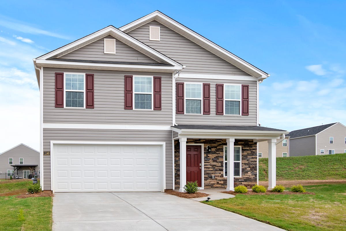 Modern grey vinyl siding home with stone accent